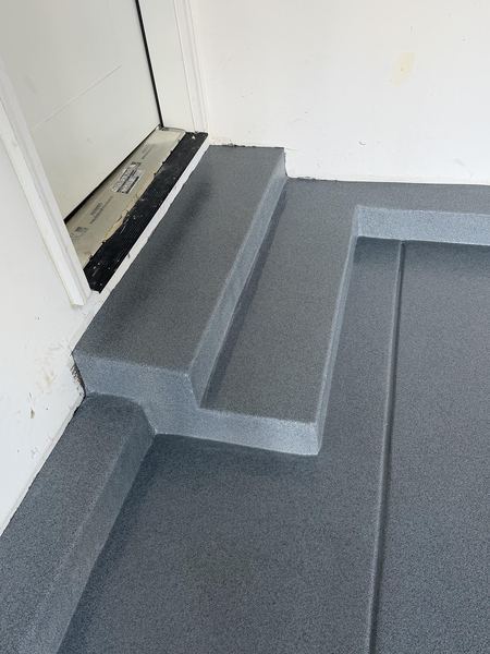 Coated garage entry step and stairs